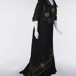 Black, silk satin dress, beading, floral embroidery. Profile.