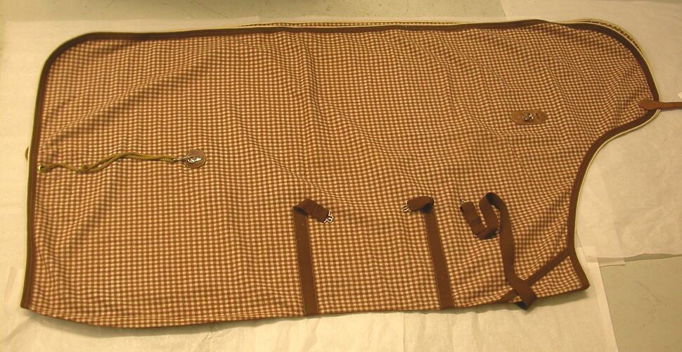 Horse blanket, brown and white pattern fabric.