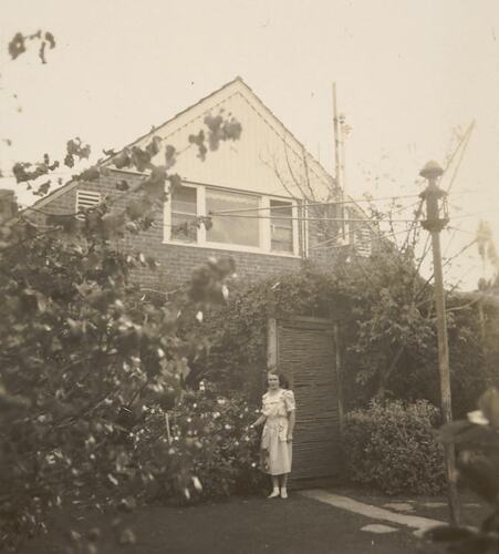Digital Photograph - Woman Standing in Back Garden by Ti Tree Fernery, Black Rock, 1948