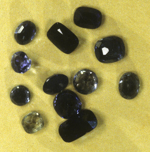 Twelve faceted sapphire specimens.