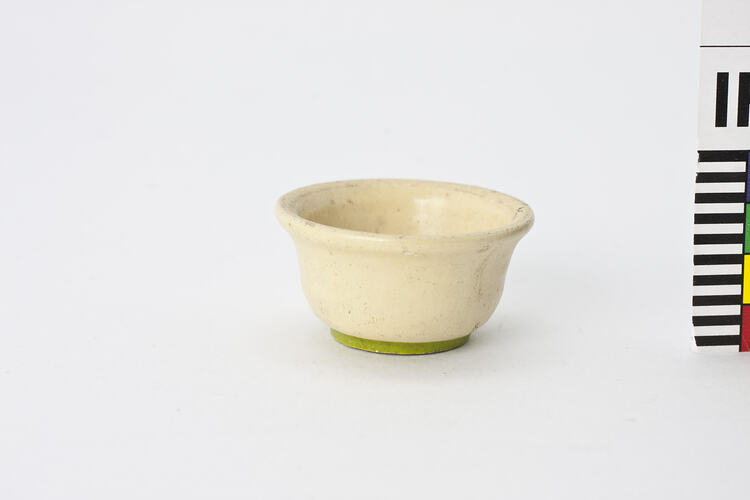 Round cream bowl with green base.
