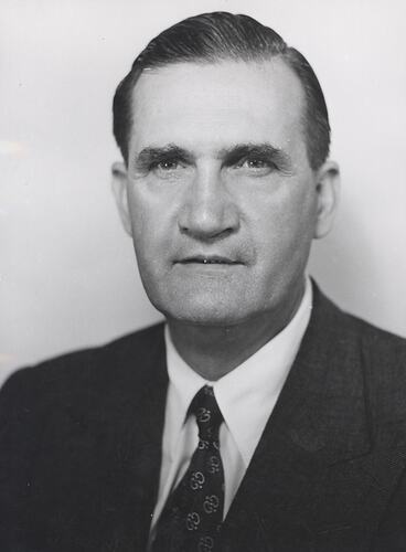 Portrait of a man wearing a suit.