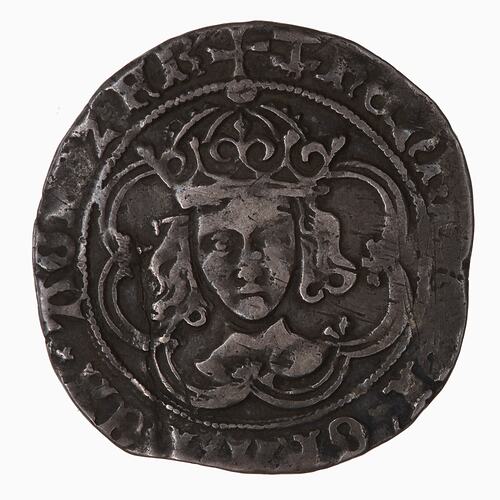 Uneven round coin with crowned male, text around.