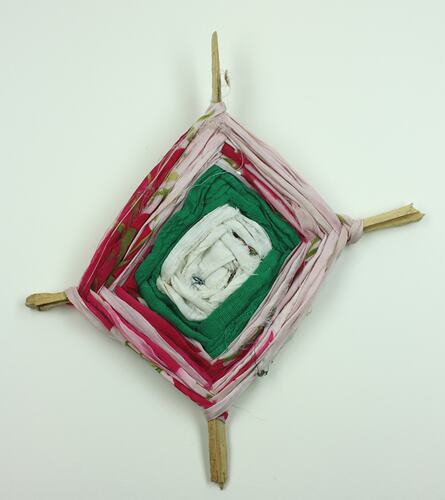 Toy carpet made from wood and wool, front view.