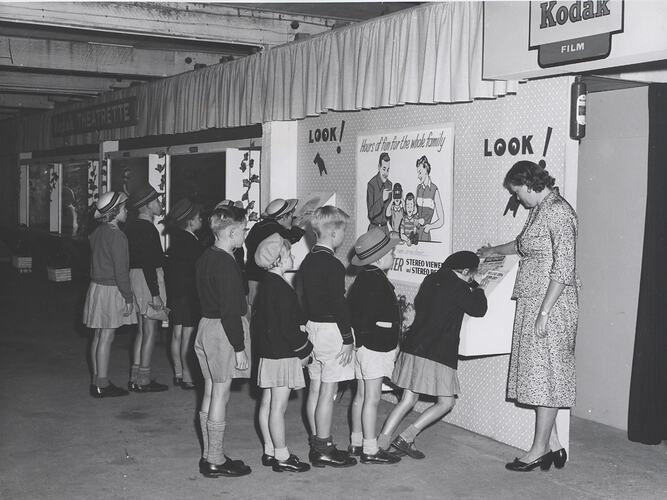 Two lines of children at exhibition display.