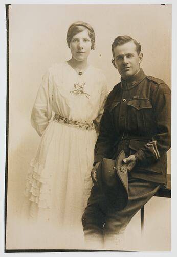Man in uniform and woman in white.