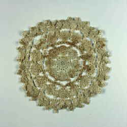 One side of stained cream doily.