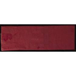 Underside of microslide covered with red paper.