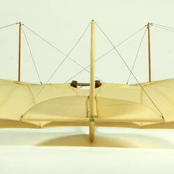 Model of off-white glider. Back view.