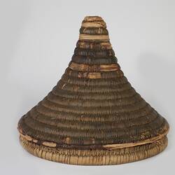 Woven fibre round basket, conical lid only.