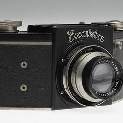 Front of metal and black plastic camera.