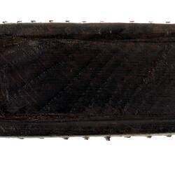Curved section of dark wooden snuff box.