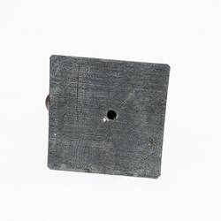 Square metal base plate with hole in centre.