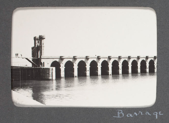 Bridge across river with many arched pylons.
