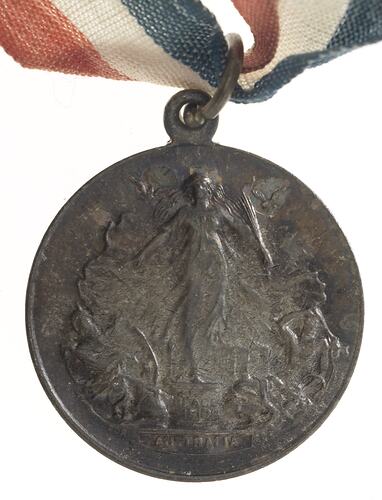 Medal of Peace figure with two flying doves on pedestal. Text below. Loop and ring at top.