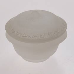 Opaque glass round spice container with lid. Narrower at base.