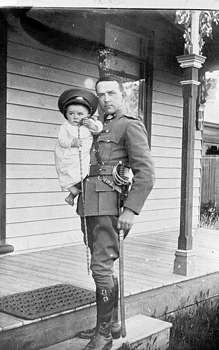 [A First World War soldier Ralph Miller holding his son Otto, Horsham, 1914.]