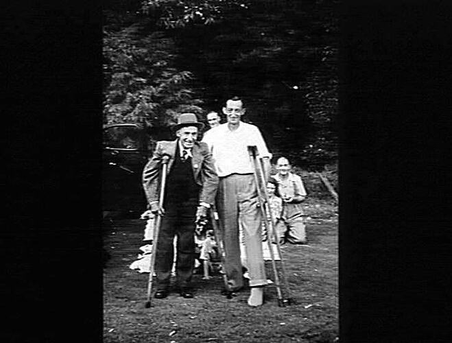 SUNSHINE HARVESTER WORKS PICNIC 1950: HELD AT FRANKSTON PARK: DESPITE THEIR DISABILITIES JACK THOMAS (LEFT) AND CHARLIE LAWSON, ATTENDED AND SPENT A HAPPY DAY: `SUNSHINE REVIEW': APRIL 1950