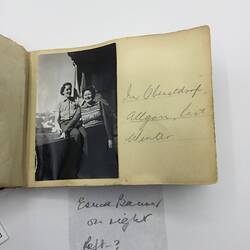 Black and white photo stuck in album with handwritten annotation in pencil along right.