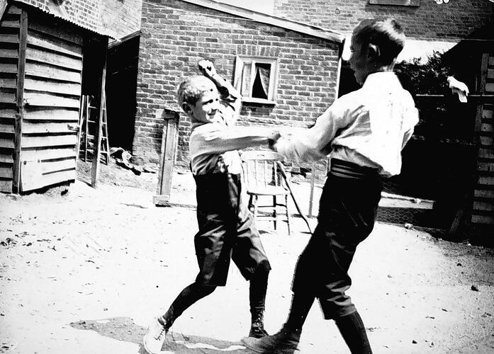 [George and Lawrence Beckett fighting in the back yard, Northcote, 1898.]