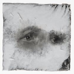 Black and white painting of eyes peering out of torn white canvas.