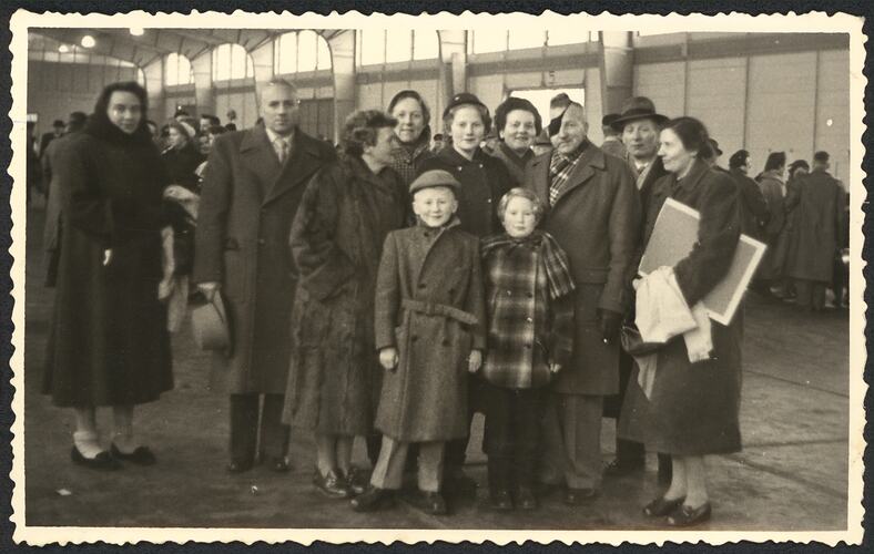 Family group posing wearing coats and hats.