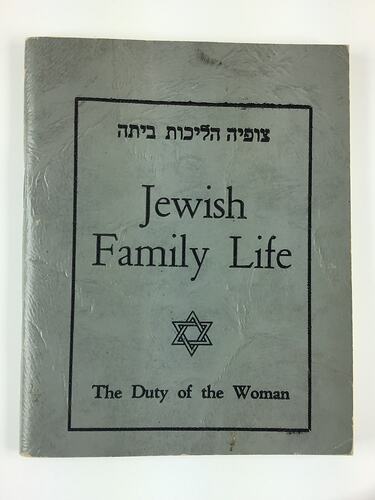 Blue grey front cover of booklet with black printed text.