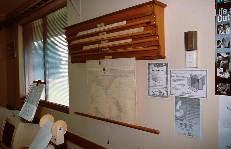 Close-up of wall-mounted roll-up charts. Melbourne Coastal Radio Station, Cape Schanck, Victoria