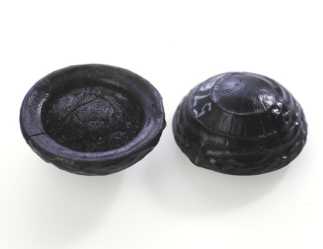 Tektites that look like glassy black buttons.