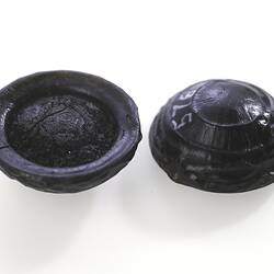 Tektites that look like glassy black buttons.