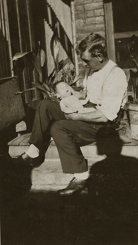 Father Sitting with Baby on Back Porch Steps, South Melbourne, 1930s