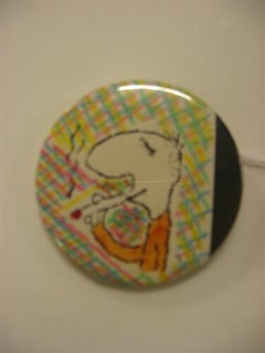 Button with caricatured illustration of human profile.