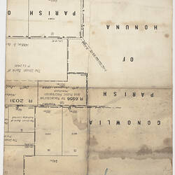 Reverse of handwritten letter. Cursive script in blue ink over printed lines and text of a town plan.