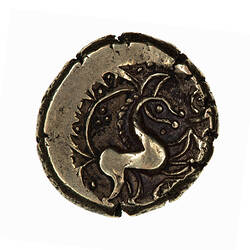 Coin, round, horse with simple line formed head; above, a curved ornament decorated with a zig-zag pattern.