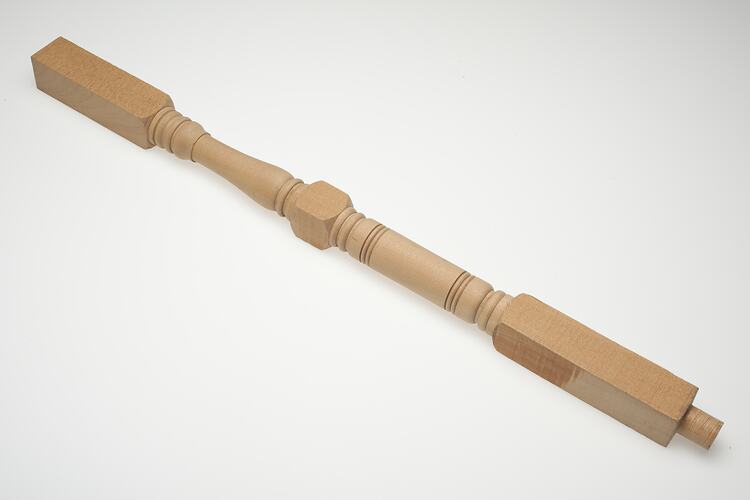 Turned wooden furniture leg.