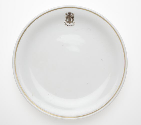 White plate with rim and crest.