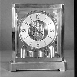 Clock in a glass case.