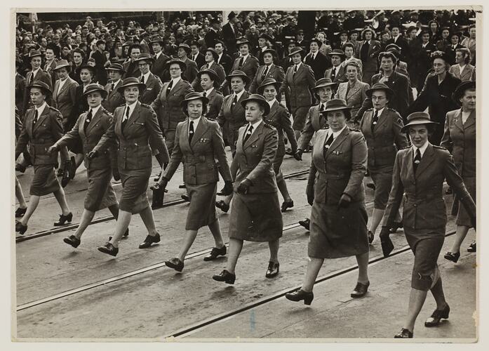 Group of woman in uniform marching.