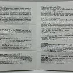 Open white book, black printed text.