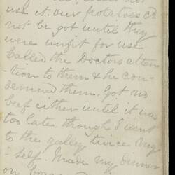 Open diary with handwritten text on discoloured worn page.