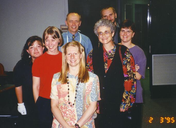 Seven people posed indoors.