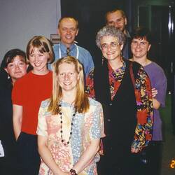 Seven people posed indoors.