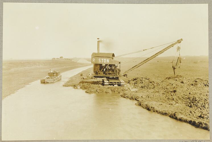 Monochrome photograph of a grab excavator.