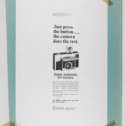 Black and white camera advertisement taped into scrapbook.