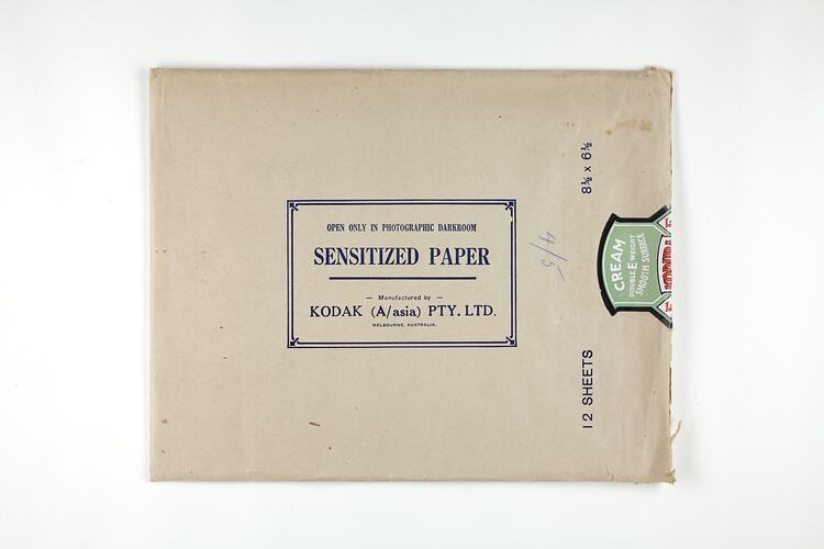 Brown paper packet sealed with printed label.