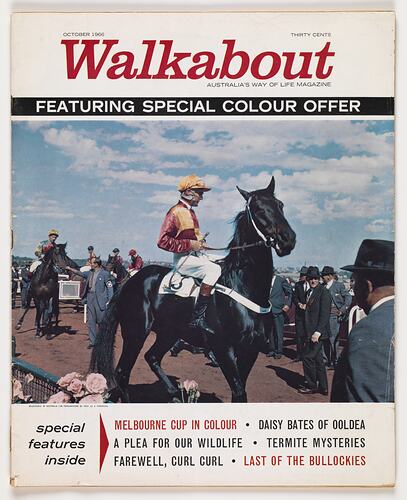 Printed colour magazine cover featuring a jockey on a horse amongst a crowd.