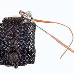 Braided leather braided pouch with metal fob watch inside.