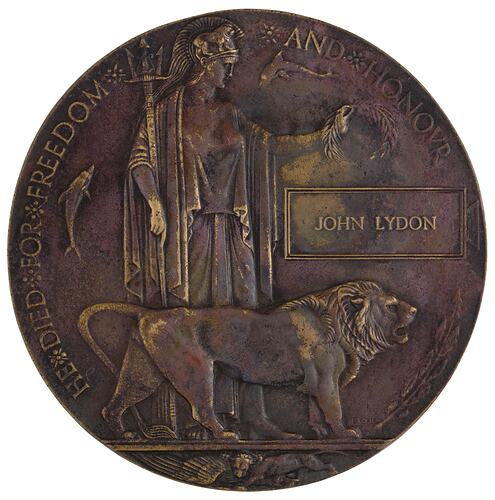 Bronze coloured medal with lion and woman holding trident and wreath.