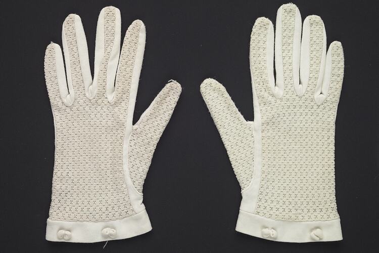 Wrist length white gloves with lace. Each glove has a two small bows on outside wrist band.