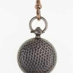 Detail of silver watch chain with silver sovereign case. Closed.